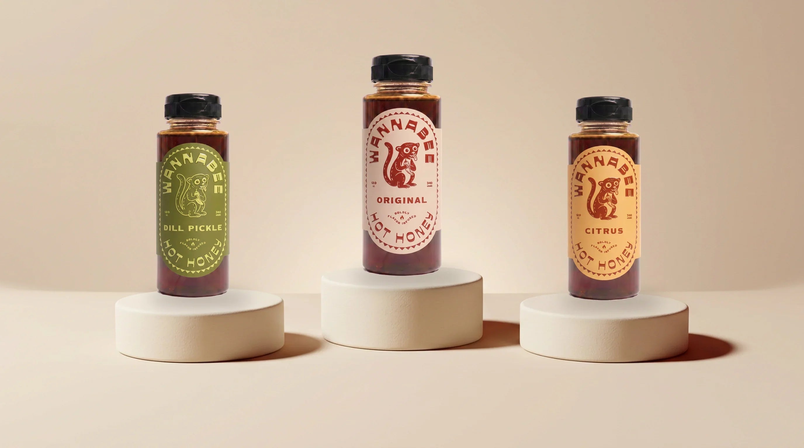 Three Wannabee hot honey bottles on cream ceramic plinths — build your own 3-pack