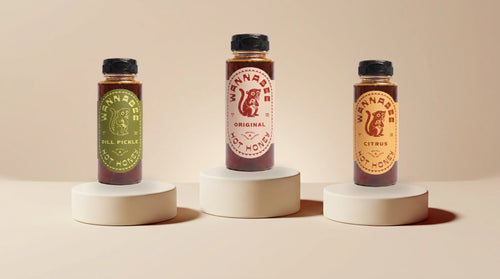 Three Wannabee hot honey bottles on cream ceramic plinths — build your own 3-pack